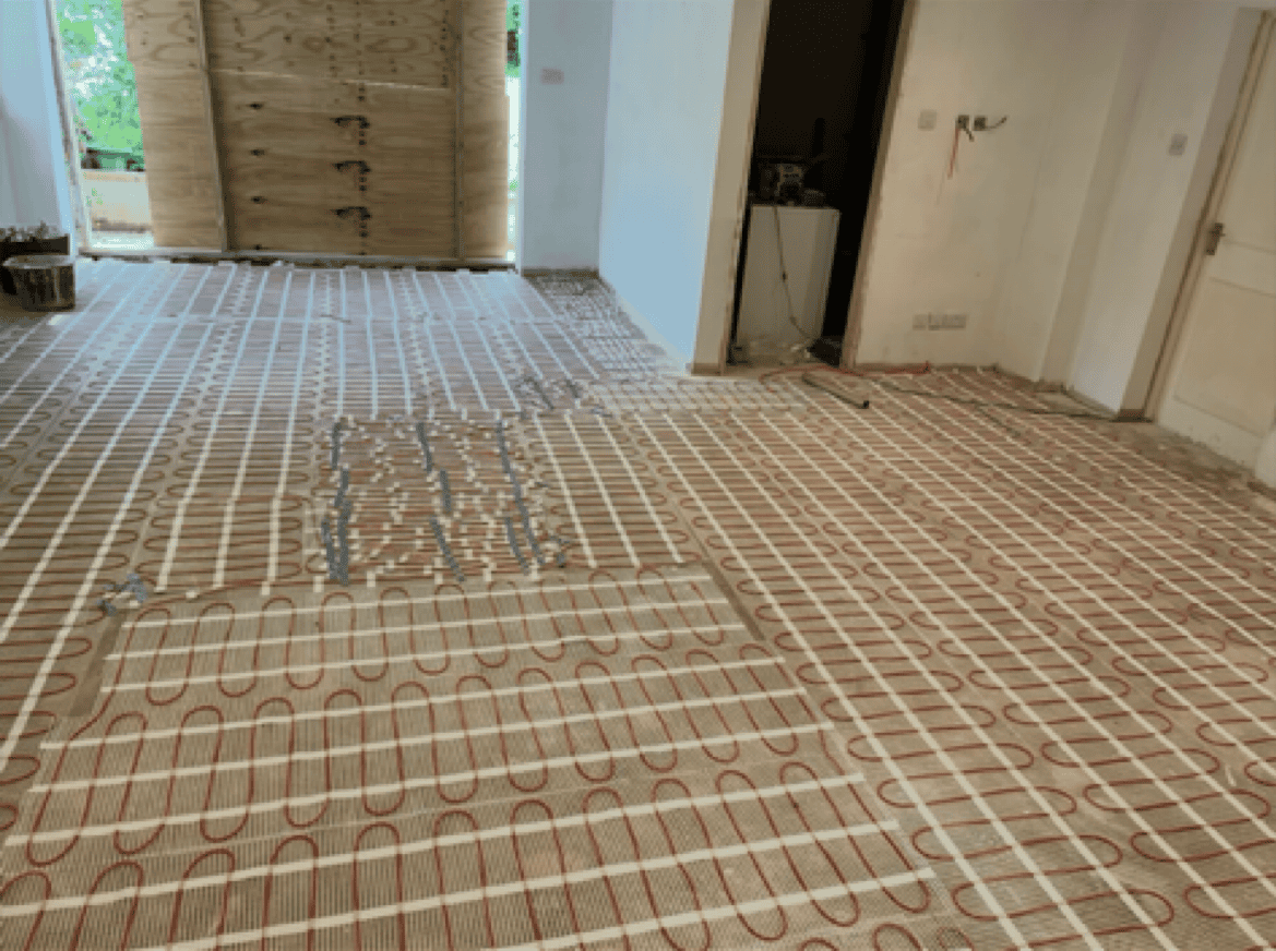 Underfloor heating pipes installed in a residential room.