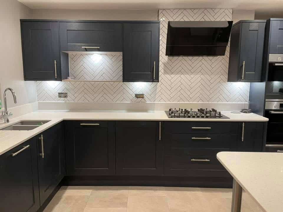 Stylish navy kitchen with modern cabinetry, built-in oven, and a gas cooktop.