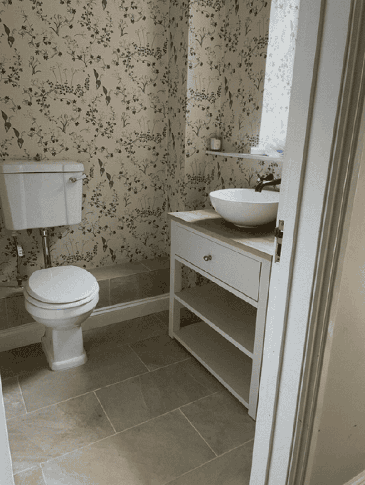 Bathroom with toilet, vanity, and sink in a contemporary setting.