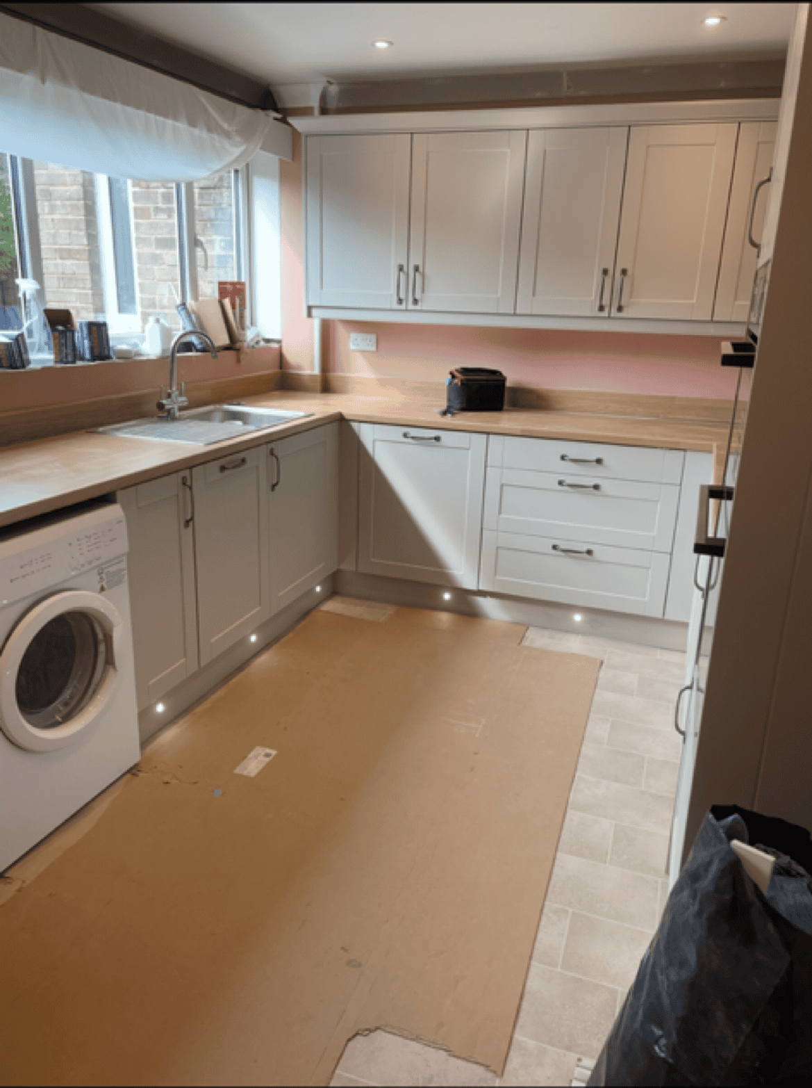 Kitchen cabinetry and countertops installation in progress.