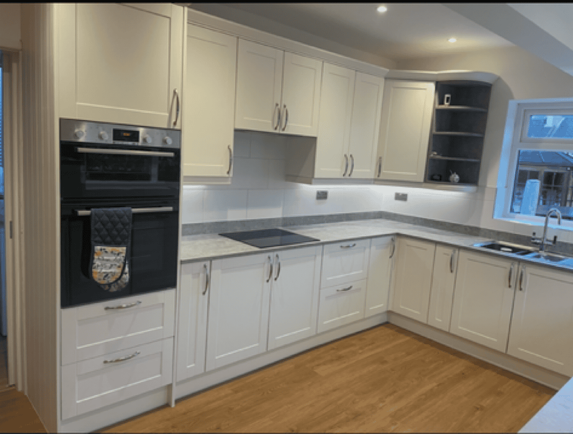 White kitchen cabinets and appliances in a contemporary home setting.
