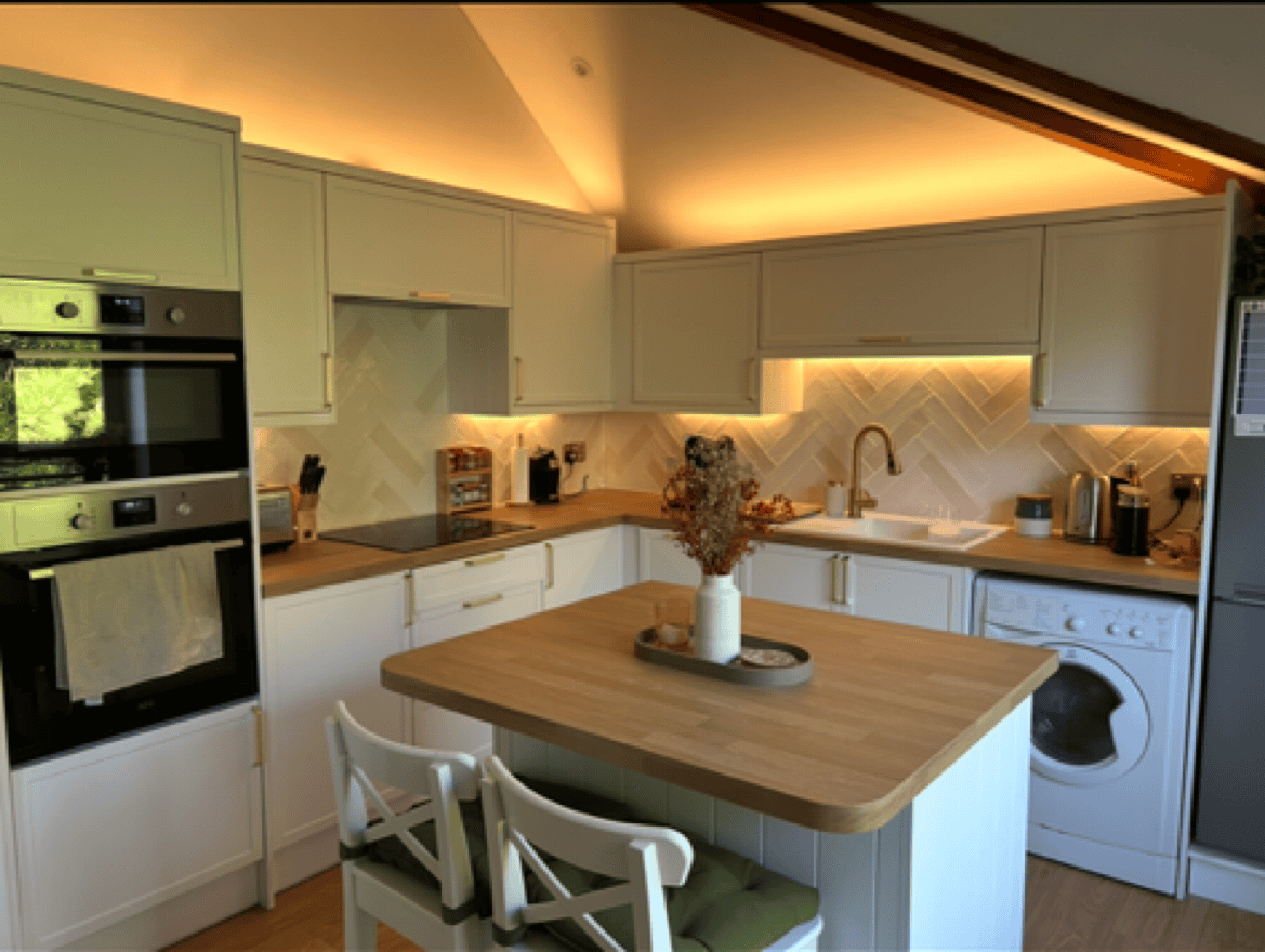 Crafting new Contemporary white kitchens with wooden countertops and under-cabinet lighting. Southampton